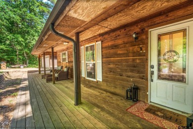 Secluded 3 bedroom 2 bath home surrounded on all 4 sides by on Holly Lake Ranch Golf Club in Texas - for sale on GolfHomes.com, golf home, golf lot