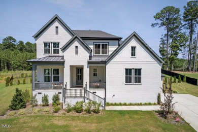 Situated atop a spacious corner lot in Hasentree, this on Hasentree Club in North Carolina - for sale on GolfHomes.com, golf home, golf lot