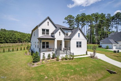 Situated atop a spacious corner lot in Hasentree, this on Hasentree Club in North Carolina - for sale on GolfHomes.com, golf home, golf lot