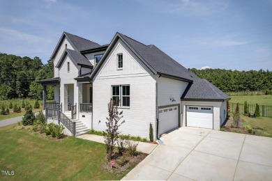 Situated atop a spacious corner lot in Hasentree, this on Hasentree Club in North Carolina - for sale on GolfHomes.com, golf home, golf lot
