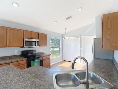 Great home with a gated entry, a well-maintained community, and on Meadow Oaks Golf and Country Club in Florida - for sale on GolfHomes.com, golf home, golf lot