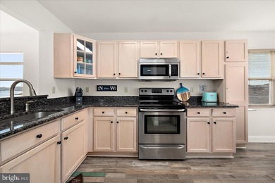 Discover waterfront living at its finest in this top floor, end on Bethany Bay Golf Club in Delaware - for sale on GolfHomes.com, golf home, golf lot