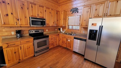 Charming Mountain Cabin with Views, Hot Tub & STR Income on Bent Creek Golf Course in Tennessee - for sale on GolfHomes.com, golf home, golf lot