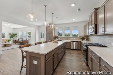 This semi-custom home in Lake Royale offers 3BR/2.5BA and a on River Golf and County Club at Lake Royale in North Carolina - for sale on GolfHomes.com, golf home, golf lot
