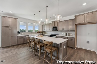 This semi-custom home in Lake Royale offers 3BR/2.5BA and a on River Golf and County Club at Lake Royale in North Carolina - for sale on GolfHomes.com, golf home, golf lot