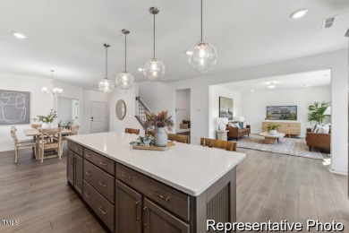 This semi-custom home in Lake Royale offers 3BR/2.5BA and a on River Golf and County Club at Lake Royale in North Carolina - for sale on GolfHomes.com, golf home, golf lot