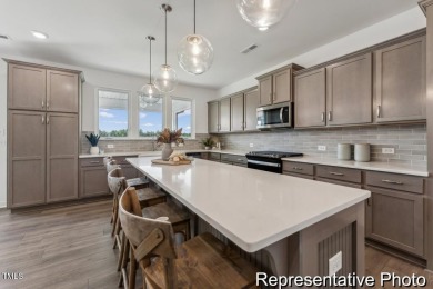 This semi-custom home in Lake Royale offers 3BR/2.5BA and a on River Golf and County Club at Lake Royale in North Carolina - for sale on GolfHomes.com, golf home, golf lot
