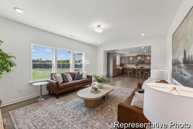 This semi-custom home in Lake Royale offers 3BR/2.5BA and a on River Golf and County Club at Lake Royale in North Carolina - for sale on GolfHomes.com, golf home, golf lot