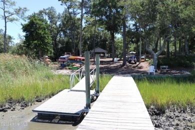 Tucked away on a quiet, canal front cul-de-sac is the home on The Country Club of the Crystal Coast in North Carolina - for sale on GolfHomes.com, golf home, golf lot