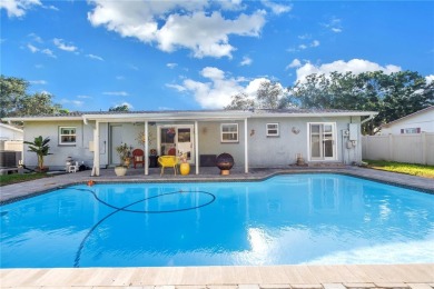 This spacious 4-bedroom, 2-bathroom pool home features a on Mangrove Bay Golf Course in Florida - for sale on GolfHomes.com, golf home, golf lot