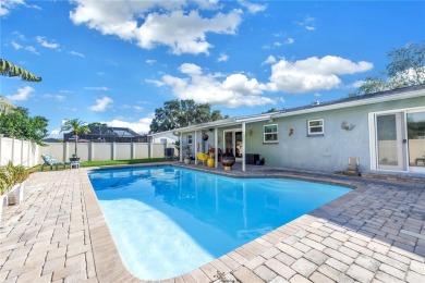This spacious 4-bedroom, 2-bathroom pool home features a on Mangrove Bay Golf Course in Florida - for sale on GolfHomes.com, golf home, golf lot