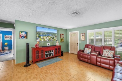 This spacious 4-bedroom, 2-bathroom pool home features a on Mangrove Bay Golf Course in Florida - for sale on GolfHomes.com, golf home, golf lot