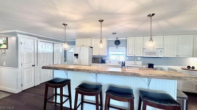 WATERFRONT HOME WITH BOAT DOCK/LIFT. Welcome to your dream home on Riverbend Golf and Country Club in Florida - for sale on GolfHomes.com, golf home, golf lot