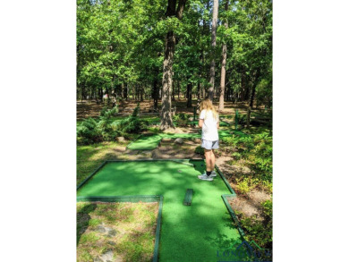 Nestled in a serene, wooded interior lot, this beautifully on Holly Lake Ranch Golf Club in Texas - for sale on GolfHomes.com, golf home, golf lot