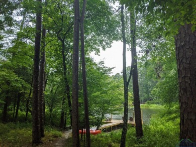 Nestled in a serene, wooded interior lot, this beautifully on Holly Lake Ranch Golf Club in Texas - for sale on GolfHomes.com, golf home, golf lot