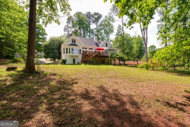 Perched on a slight slope overlooking the 11th fairway of the on Jennings Mill Country Club in Georgia - for sale on GolfHomes.com, golf home, golf lot