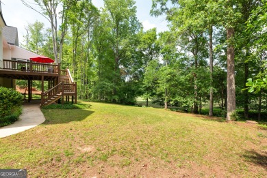 Perched on a slight slope overlooking the 11th fairway of the on Jennings Mill Country Club in Georgia - for sale on GolfHomes.com, golf home, golf lot