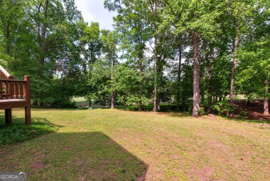 Perched on a slight slope overlooking the 11th fairway of the on Jennings Mill Country Club in Georgia - for sale on GolfHomes.com, golf home, golf lot