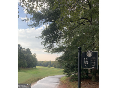 Perched on a slight slope overlooking the 11th fairway of the on Jennings Mill Country Club in Georgia - for sale on GolfHomes.com, golf home, golf lot
