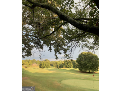 Perched on a slight slope overlooking the 11th fairway of the on Jennings Mill Country Club in Georgia - for sale on GolfHomes.com, golf home, golf lot