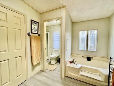Lovely home with new wood laminate flooring throughout & extra on Indianwood Golf and Country Club in Florida - for sale on GolfHomes.com, golf home, golf lot