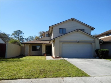 A solid two-story 4 bed/ 2.5 bath, 2 car garage, pool home is on Northdale Golf and Tennis Club in Florida - for sale on GolfHomes.com, golf home, golf lot