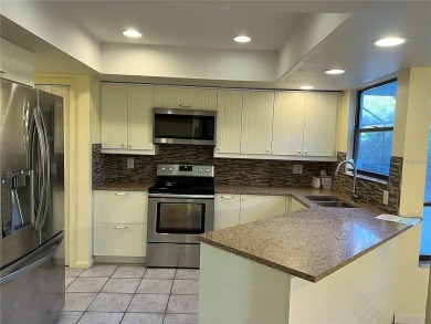 A solid two-story 4 bed/ 2.5 bath, 2 car garage, pool home is on Northdale Golf and Tennis Club in Florida - for sale on GolfHomes.com, golf home, golf lot