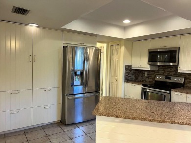 A solid two-story 4 bed/ 2.5 bath, 2 car garage, pool home is on Northdale Golf and Tennis Club in Florida - for sale on GolfHomes.com, golf home, golf lot