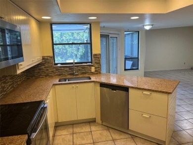 A solid two-story 4 bed/ 2.5 bath, 2 car garage, pool home is on Northdale Golf and Tennis Club in Florida - for sale on GolfHomes.com, golf home, golf lot