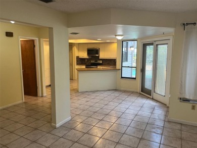 A solid two-story 4 bed/ 2.5 bath, 2 car garage, pool home is on Northdale Golf and Tennis Club in Florida - for sale on GolfHomes.com, golf home, golf lot