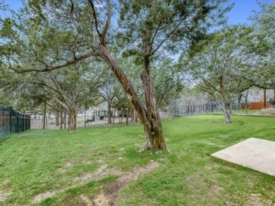 Adorable home with large tree-covered and fenced back yard on Point Venture Golf Club on Lake Travis in Texas - for sale on GolfHomes.com, golf home, golf lot