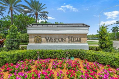 Luxury living awaits in this stunning one-story pool home on the on Weston Hills Country Club in Florida - for sale on GolfHomes.com, golf home, golf lot
