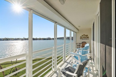 Straight from the pages of Coastal Living, this pristine on Isla Del Sol Yacht and Country Club in Florida - for sale on GolfHomes.com, golf home, golf lot
