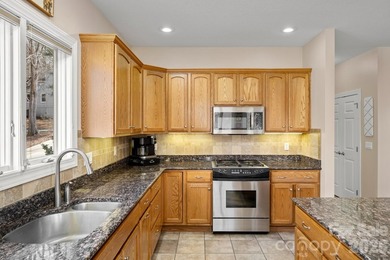 Perched on a gentle hill with sweeping views of the 7th and 9th on Cummings Cove Golf and Country Club in North Carolina - for sale on GolfHomes.com, golf home, golf lot