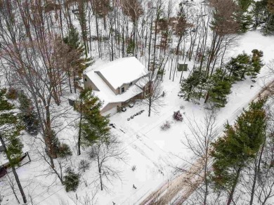 Discover the perfect blend of privacy and convenience in this on Charlevoix Golf and Country Club in Michigan - for sale on GolfHomes.com, golf home, golf lot