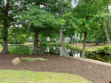 Nestled in a quiet cul-de-sac and backed by a serene pond shaded on Members Club At St. James Plantation in North Carolina - for sale on GolfHomes.com, golf home, golf lot