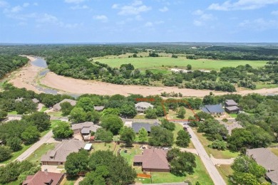 This riverfront lot offers an exceptional blend of natural on Pecan Plantation Country Club in Texas - for sale on GolfHomes.com, golf home, golf lot