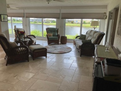 BEAUTIFULLY RENOVATED HURRICANE IMPACT WINDOWS NEW TRAVERTINE on Plantation Golf and Country Club in Florida - for sale on GolfHomes.com, golf home, golf lot