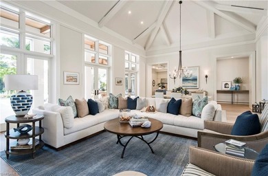 Discover refined coastal luxury in this exceptional estate on Club at Pelican Bay Golf Course in Florida - for sale on GolfHomes.com, golf home, golf lot