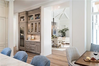 Discover refined coastal luxury in this exceptional estate on Club at Pelican Bay Golf Course in Florida - for sale on GolfHomes.com, golf home, golf lot