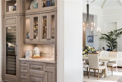 Discover refined coastal luxury in this exceptional estate on Club at Pelican Bay Golf Course in Florida - for sale on GolfHomes.com, golf home, golf lot