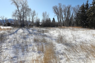 Enjoy beautiful Grand Teton views from this premier .84 acre lot on Jackson Hole Golf and Tennis Club in Wyoming - for sale on GolfHomes.com, golf home, golf lot