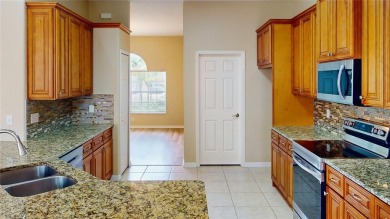 Welcome to this beautifully updated 5-bedroom, 3-bath pool home on The Grand Club - Pine Lakes Course in Florida - for sale on GolfHomes.com, golf home, golf lot