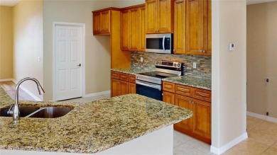 Welcome to this beautifully updated 5-bedroom, 3-bath pool home on The Grand Club - Pine Lakes Course in Florida - for sale on GolfHomes.com, golf home, golf lot