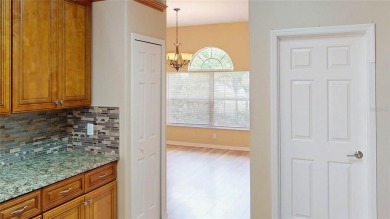 Welcome to this beautifully updated 5-bedroom, 3-bath pool home on The Grand Club - Pine Lakes Course in Florida - for sale on GolfHomes.com, golf home, golf lot