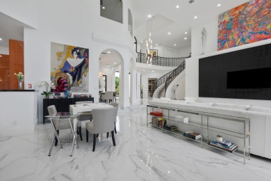 Experience breathtaking long lake views from this grand estate on St. Andrews Country Club of Boca Raton in Florida - for sale on GolfHomes.com, golf home, golf lot
