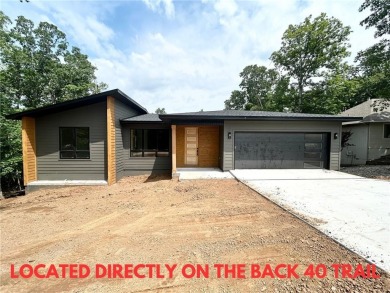 New construction on a spacious .31-acre wooded lot with a level on Bella Vista - Metfield Golf Complex and Country Club in Arkansas - for sale on GolfHomes.com, golf home, golf lot