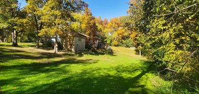 Tucked beneath a canopy of towering trees, located on a quiet on Biltmore Country Club in Illinois - for sale on GolfHomes.com, golf home, golf lot