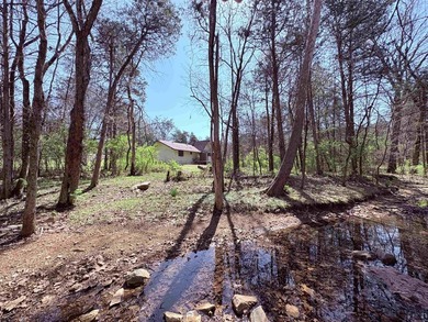 4-bedroom, 3-bath home on approximately 0.69 acres with a wet on Cherokee Village North Course in Arkansas - for sale on GolfHomes.com, golf home, golf lot