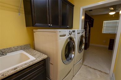 This oversized Lantana waterfront home with rare Water and Golf on Glenview Championship Golf and Country Club in Florida - for sale on GolfHomes.com, golf home, golf lot